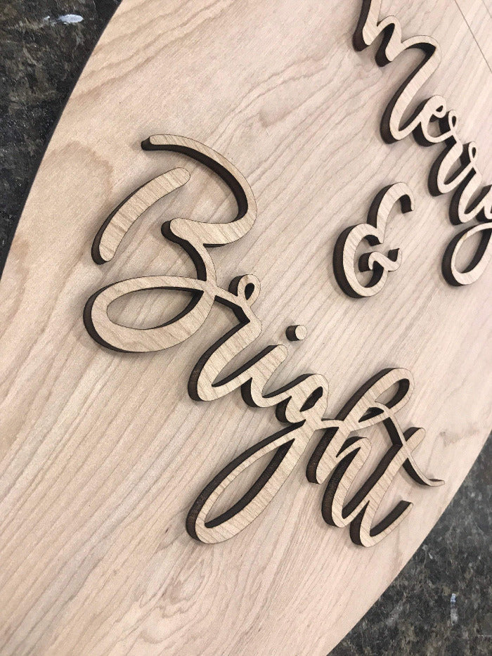 up close picture of merry & bright 3d laser cut wood lettering