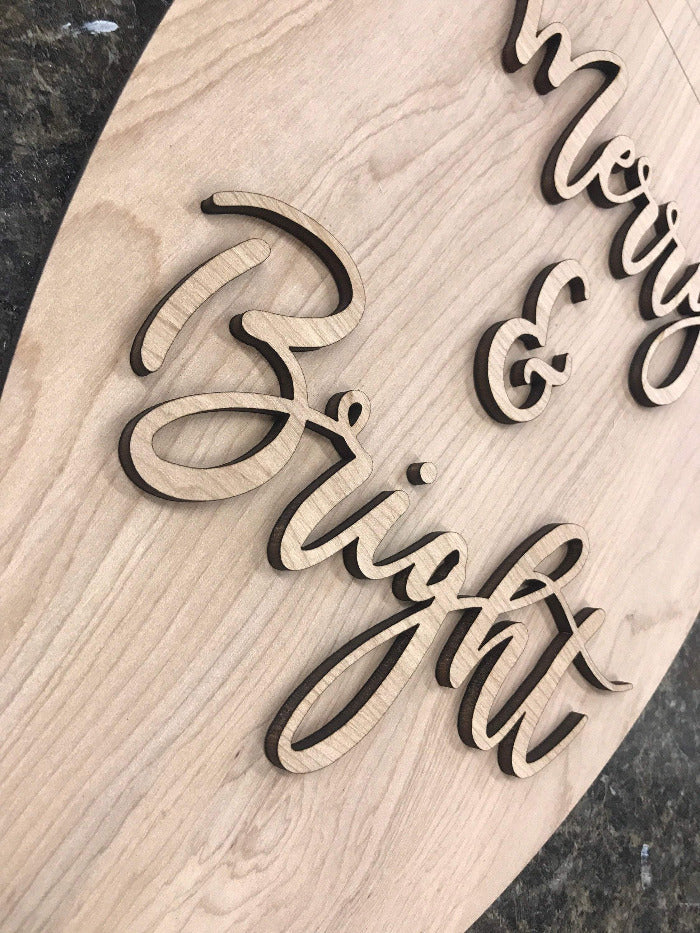 up close picture of merry & bright 3d laser cut wood lettering 