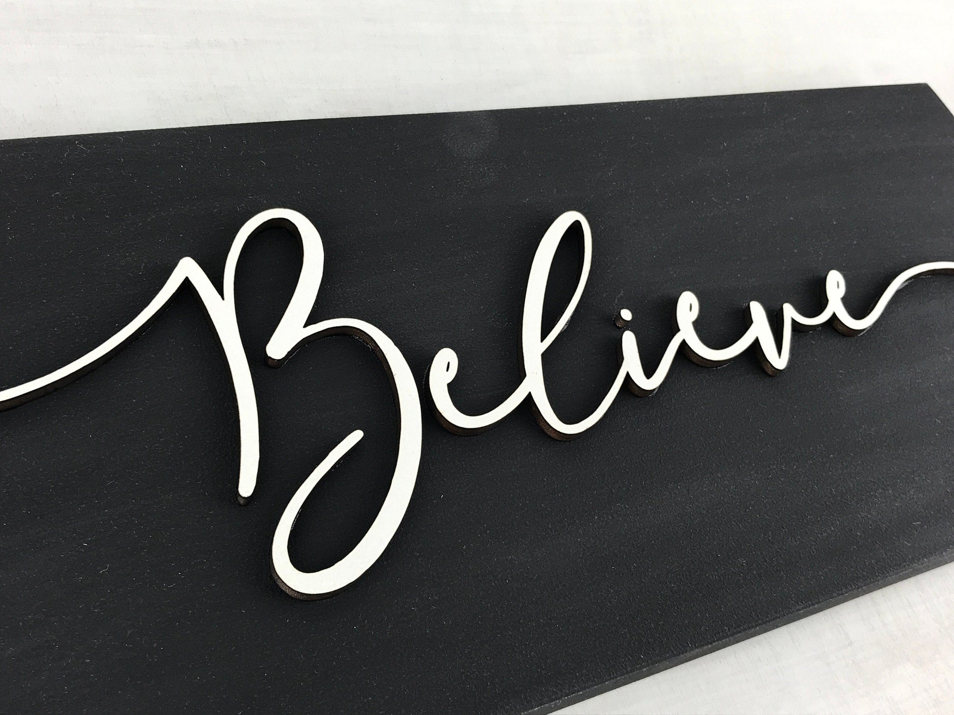 black and white believe sign